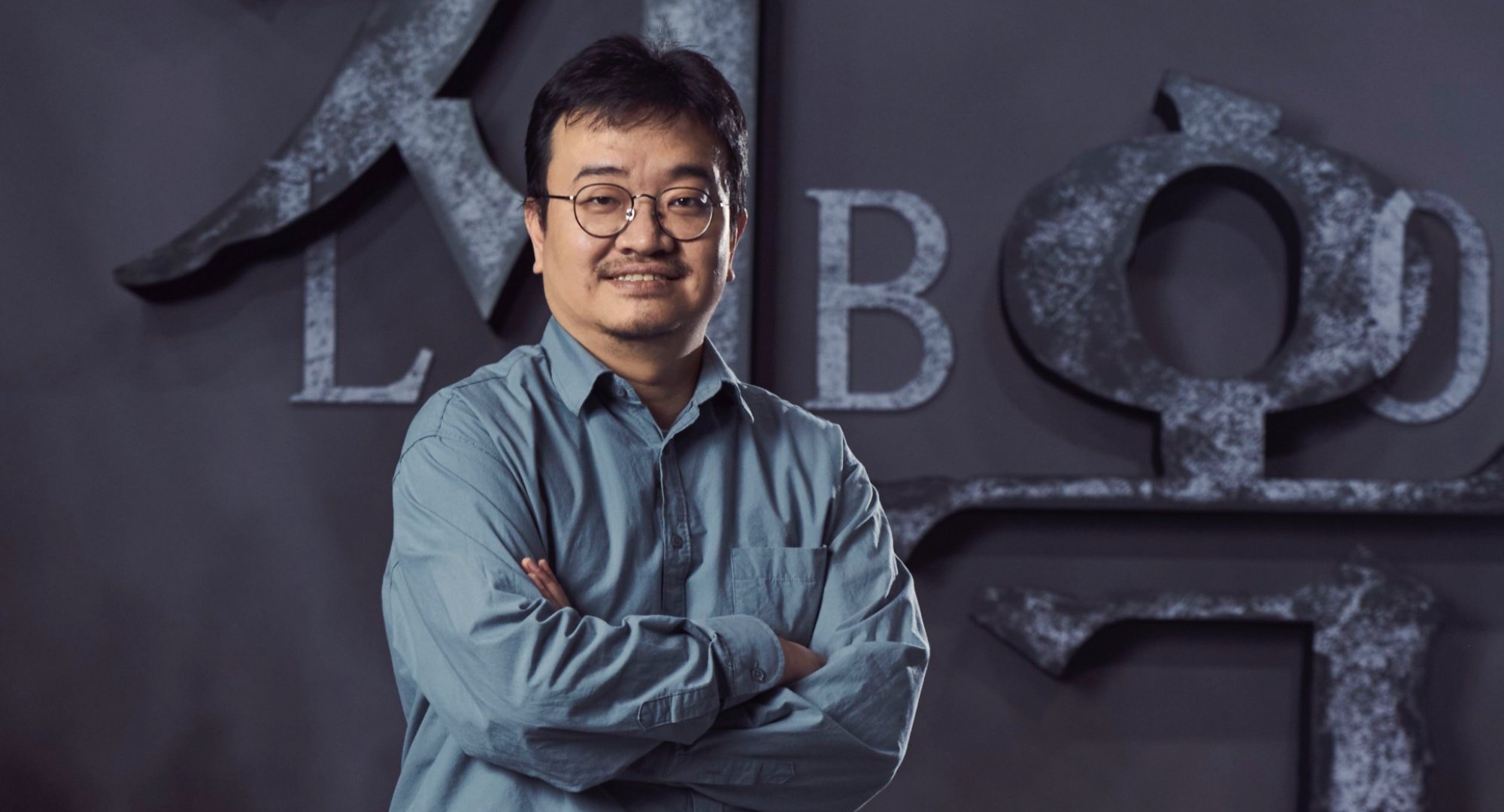 'Hellbound' by director Yeon Sang-ho at Netflix press event in blue button-up shirt.