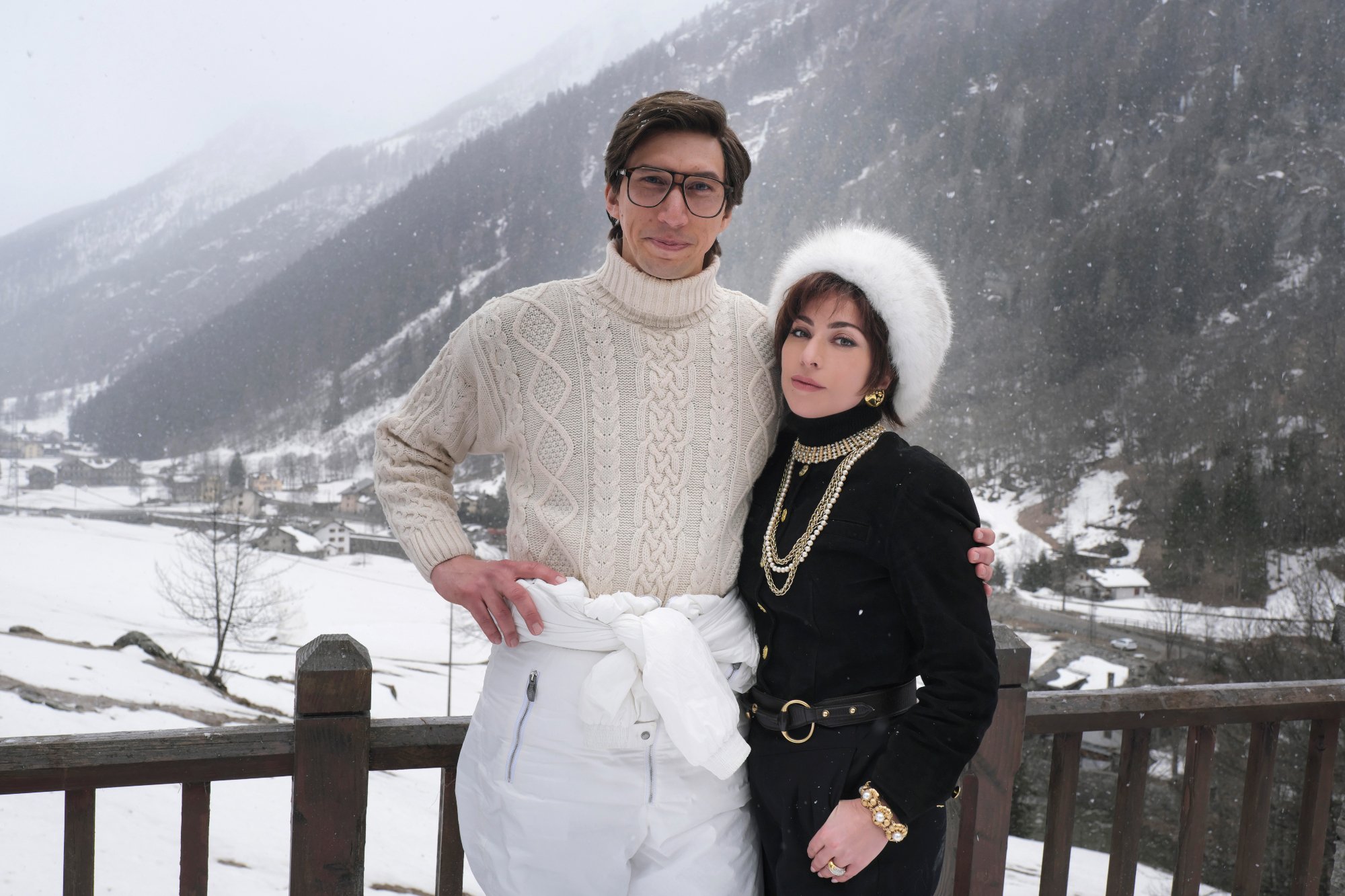'House of Gucci' review stars Adam Driver as Maurizio Gucci and Lady Gaga stars as Patrizia Reggiani in snow clothes with a snow-covered landscape behind them