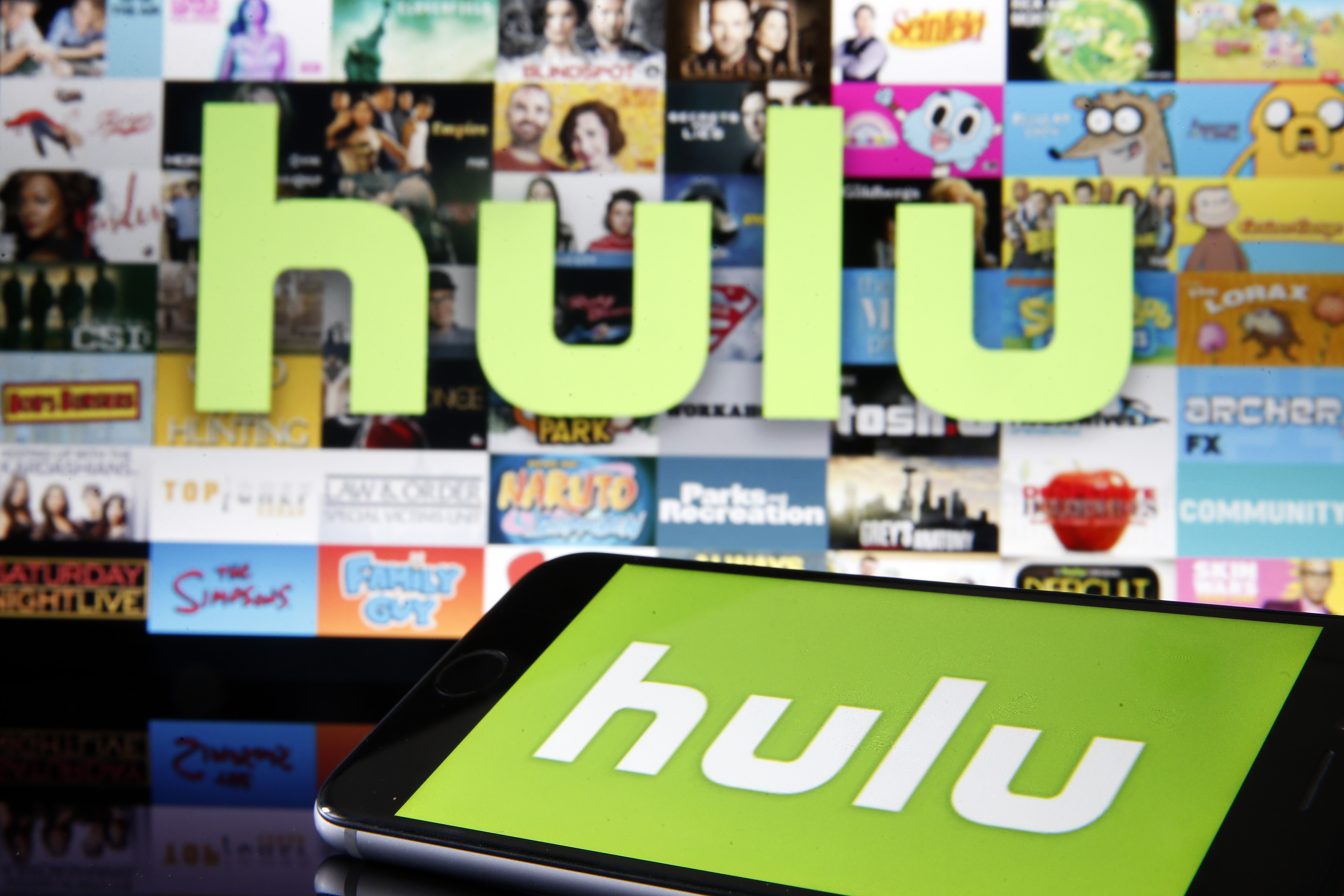 Hulu logo over thumbnails of show with a phone with the Hulu logo in the foreground