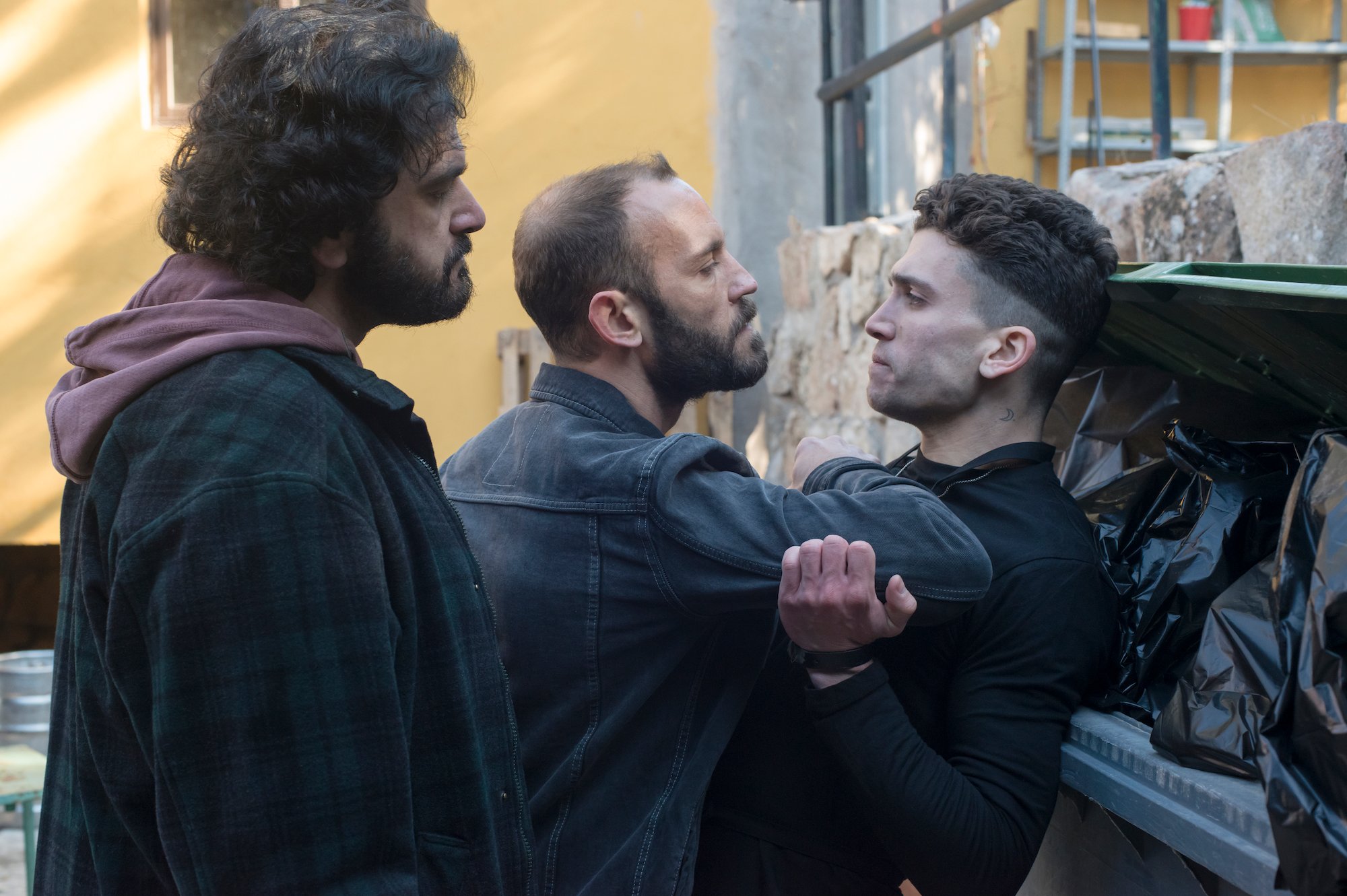 Jaime Lorente fighting with two grown men in 'Elite' Season 1.