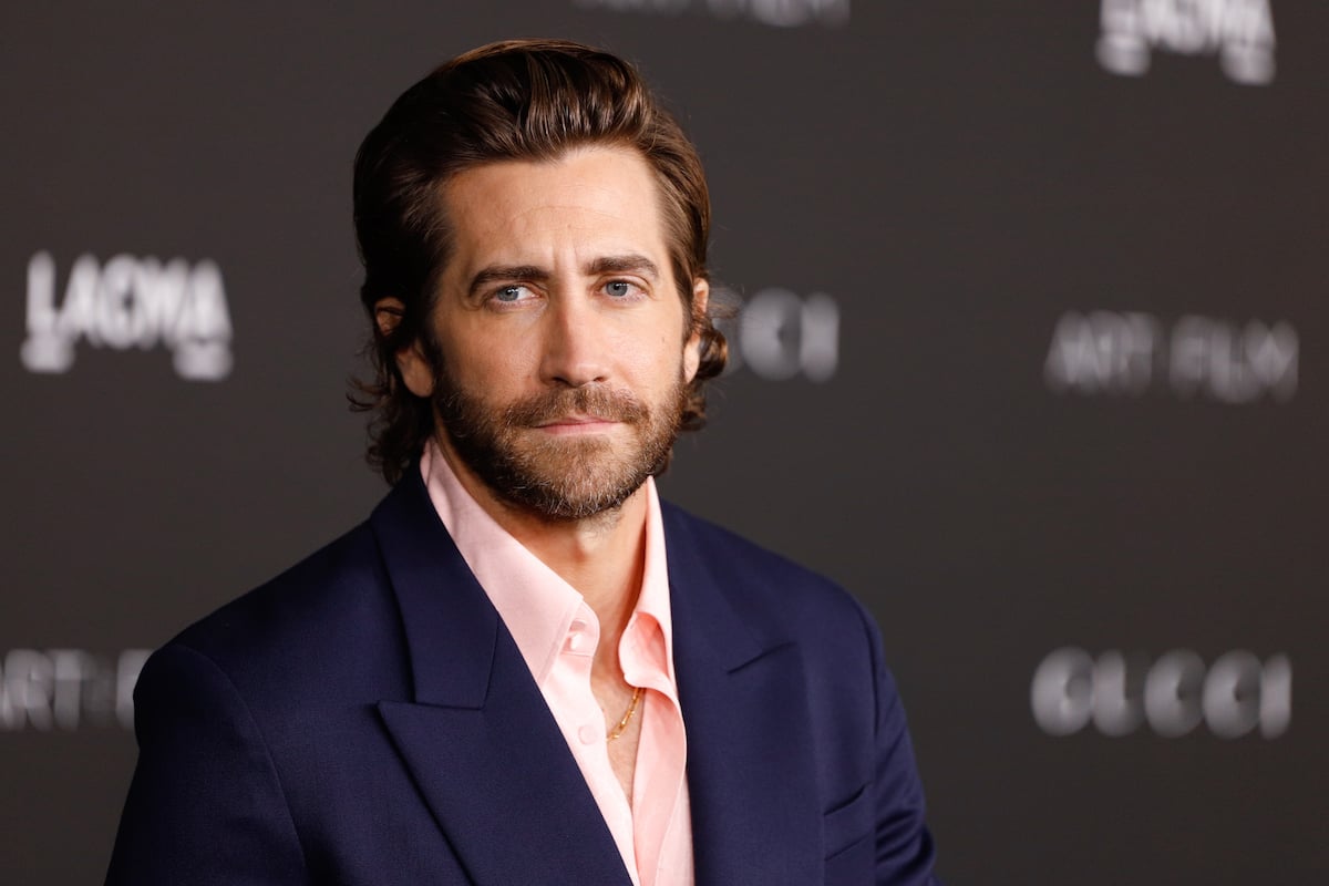 Jake Gyllenhaal smiles for the camera at an event.
