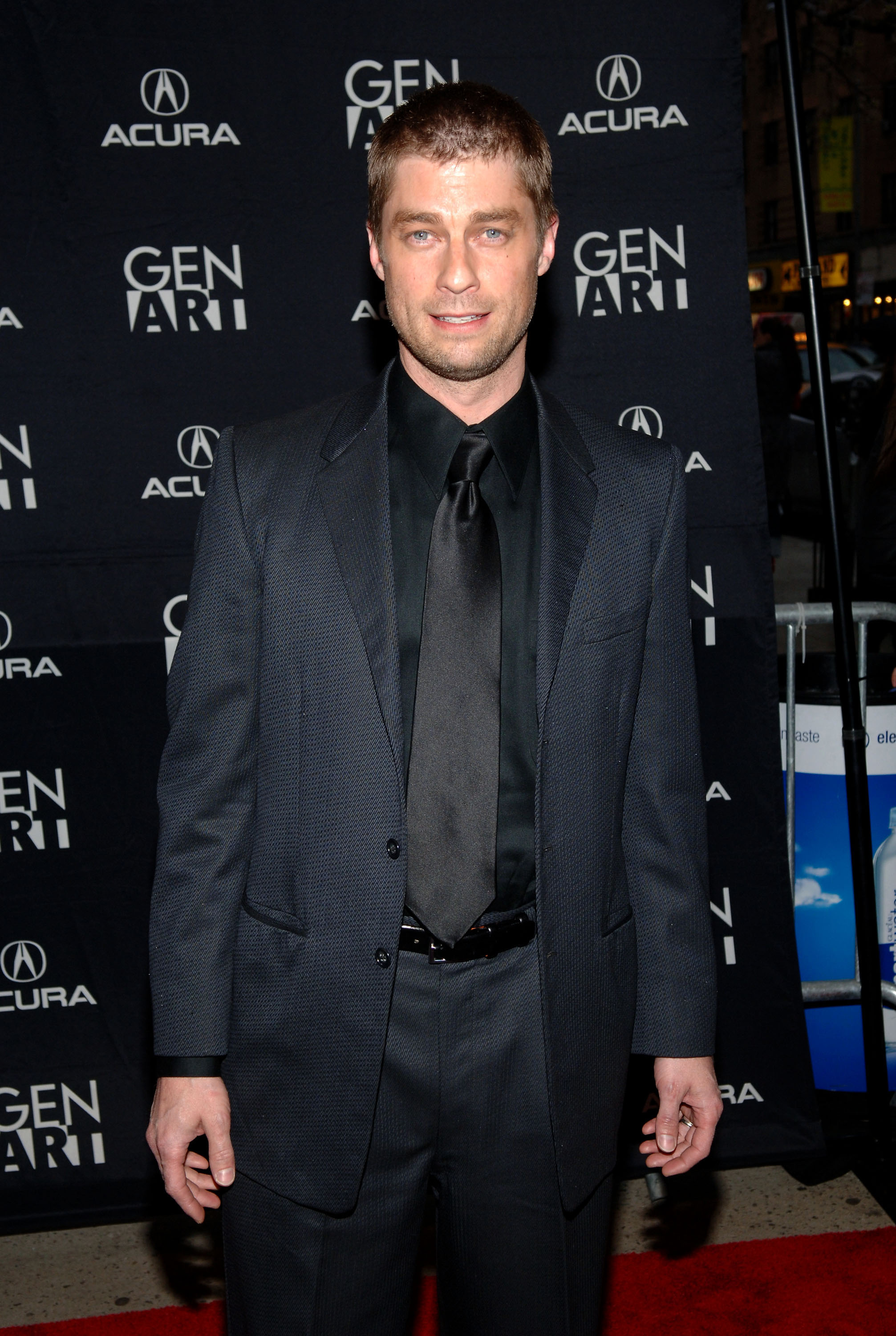 'The Young and the Restless' actor Jamison Jones wearing a black suit and posing on the red carpet.