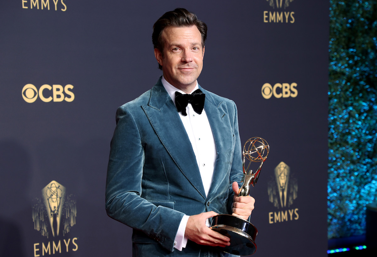 Jason Sudeikis smiles and holds an award.