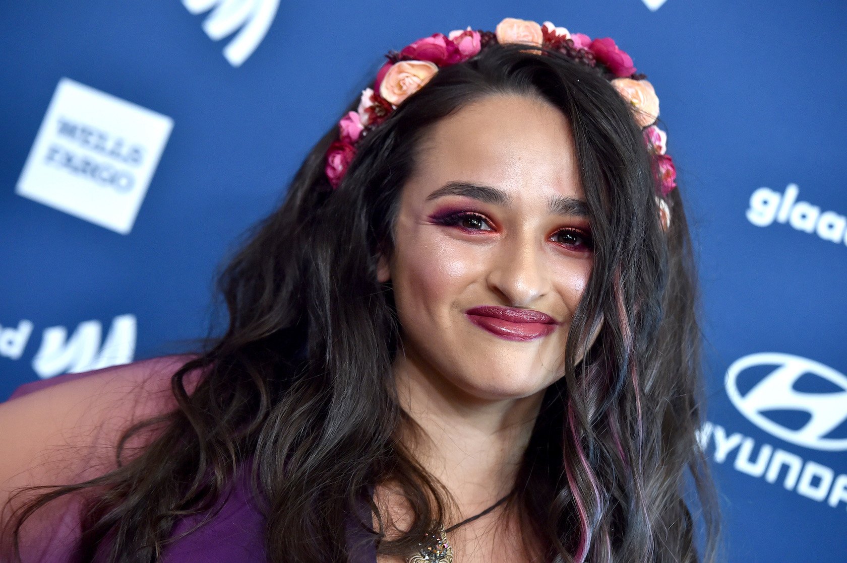 A close-up of Jazz Jennings from 'I Am Jazz' Season 7 smiling at an event