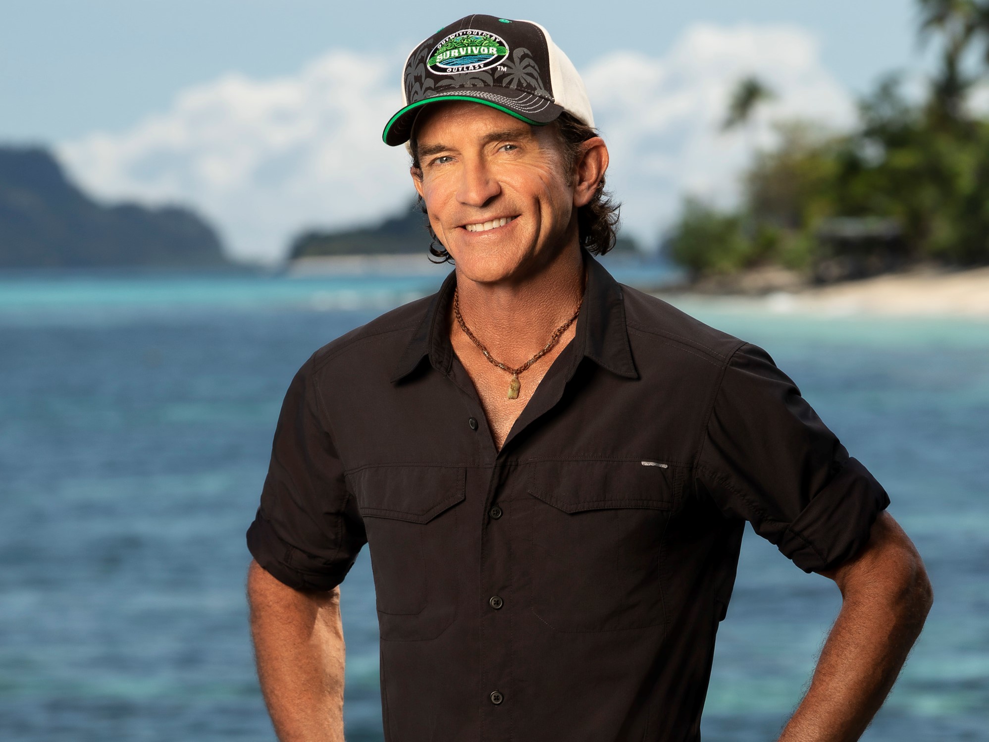 'Survivor' Season 42 host Jeff Probst wears a black short-sleeved button-up shirt and 'Survivor' hat.