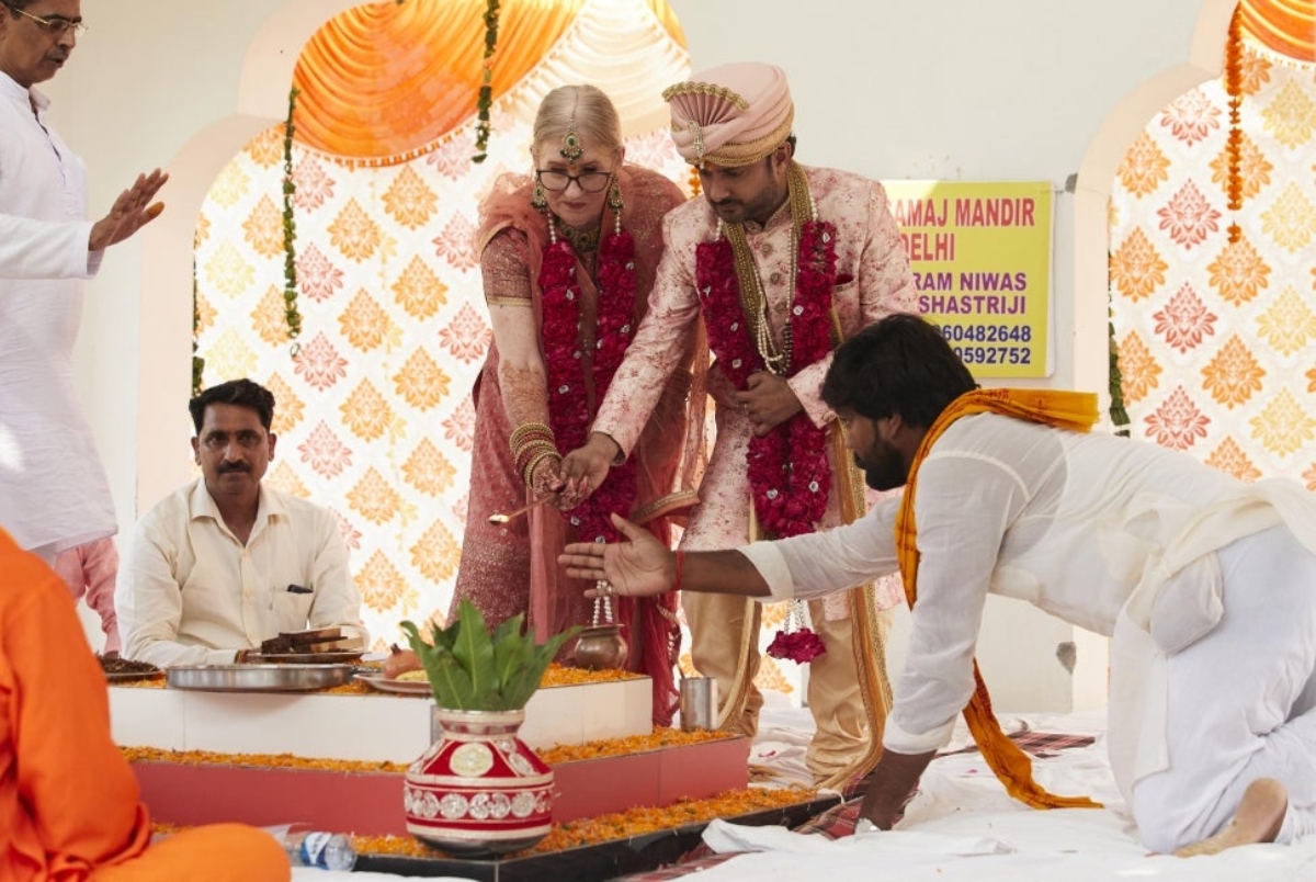 Jenny Slatten and Sumit Singh cutting their cake together during their wedding ceremony in an Indian temple on '90 Day Fiancé: The Other Way' Season 3