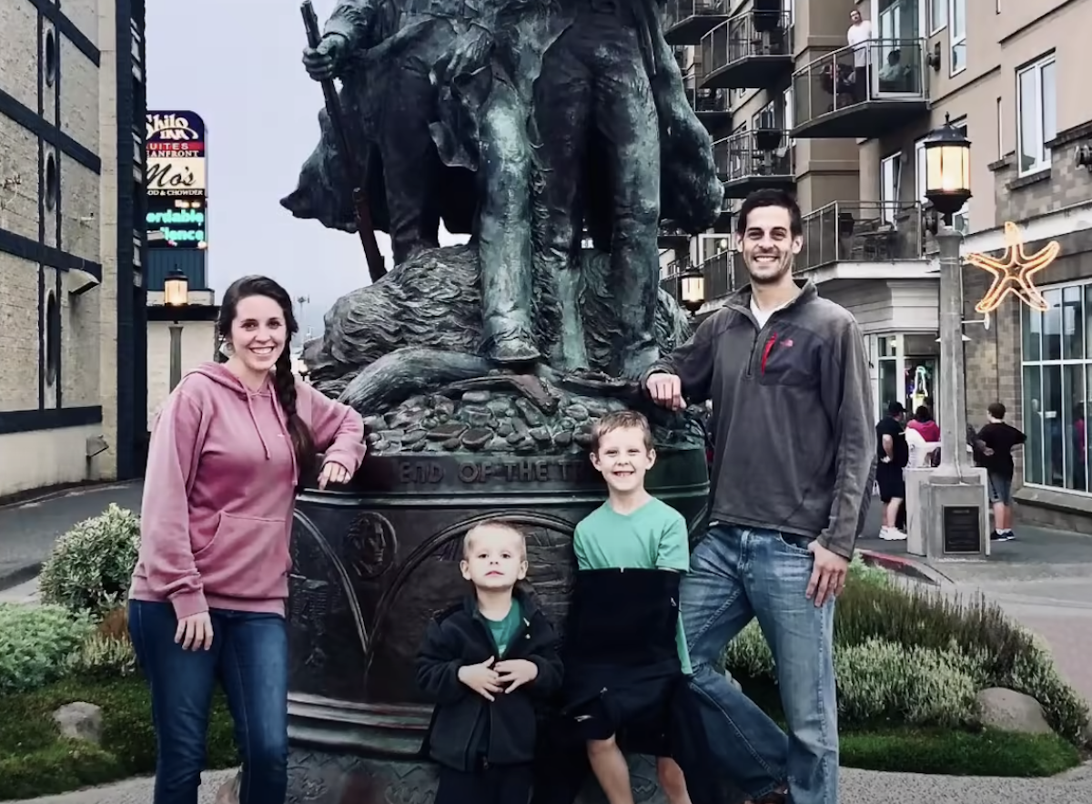 Derick, Jill, and the Dillard boys pose with a statue in Oregon