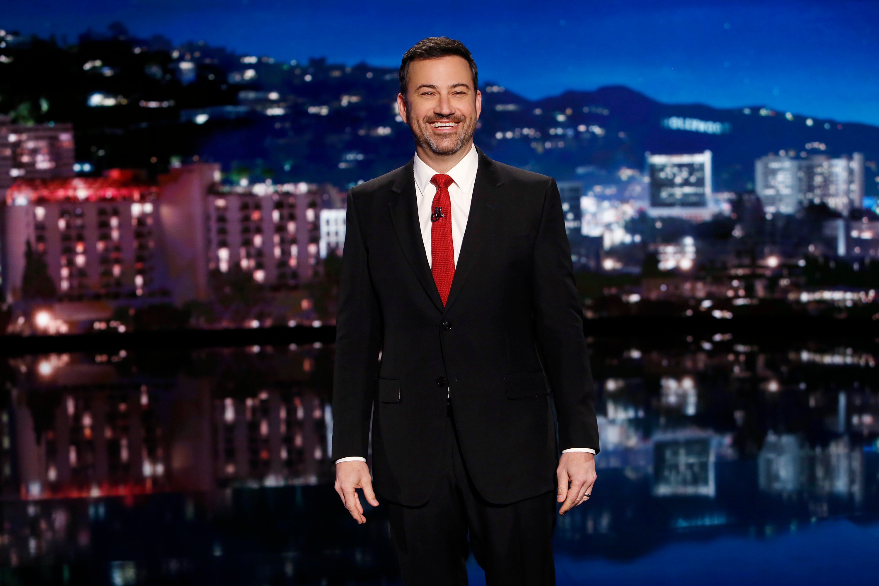 Jimmy Kimmel, who added himself into the 'Spider-Man: No Way Home' trailer, wears a black suit over a white shirt and red tie.