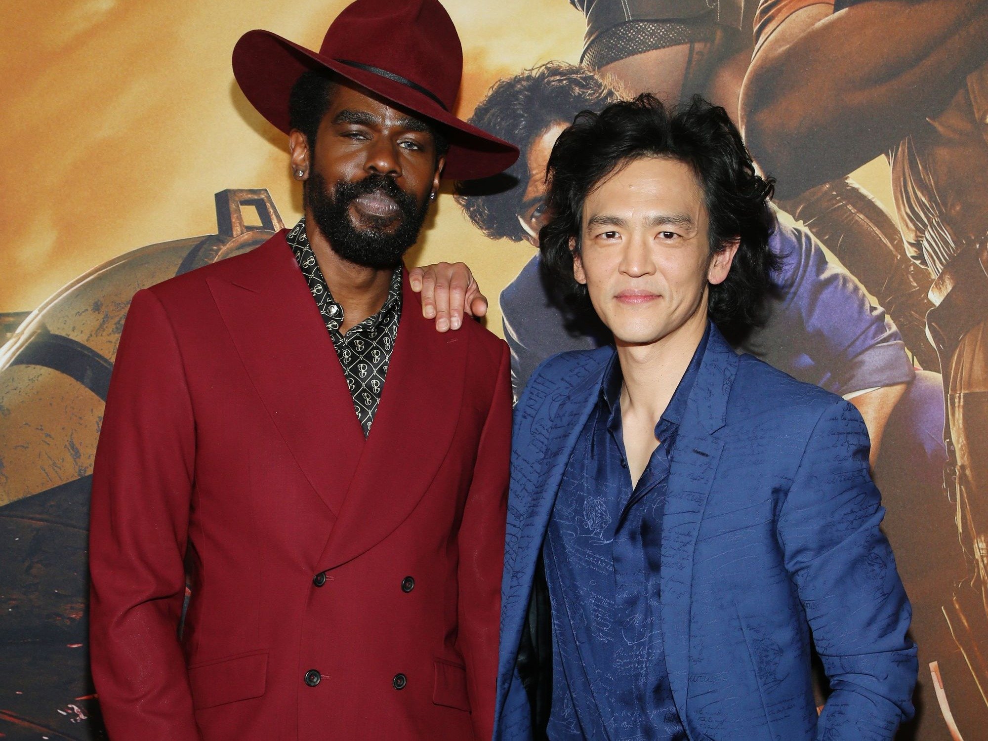 Mustafa Shakir and John Cho, who play Jet Black and Spike Spiegel in Netflix's live-action 'Cowboy Bebop.' They're standing next to one another and wearing suits.