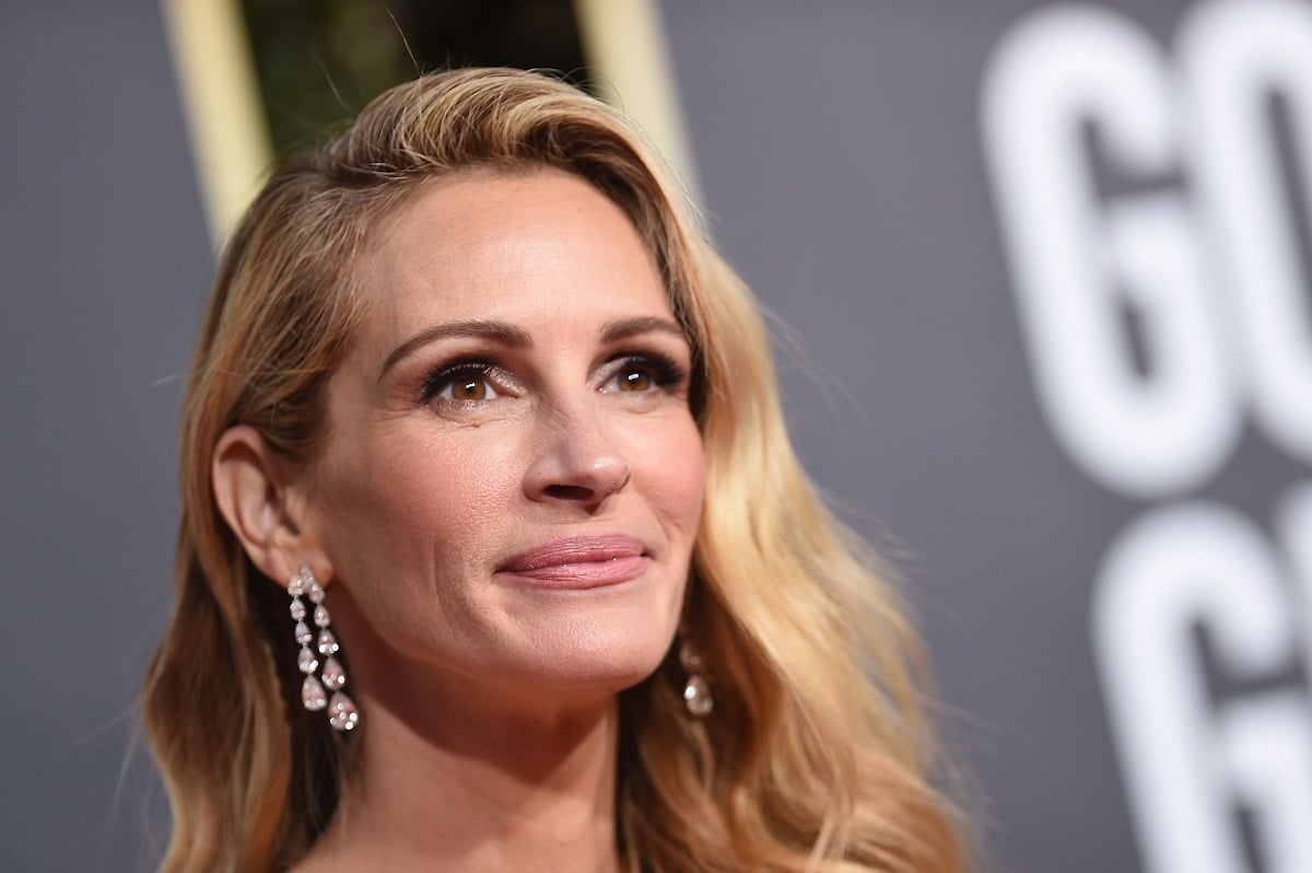 Julia Roberts smirking while wearing earrings