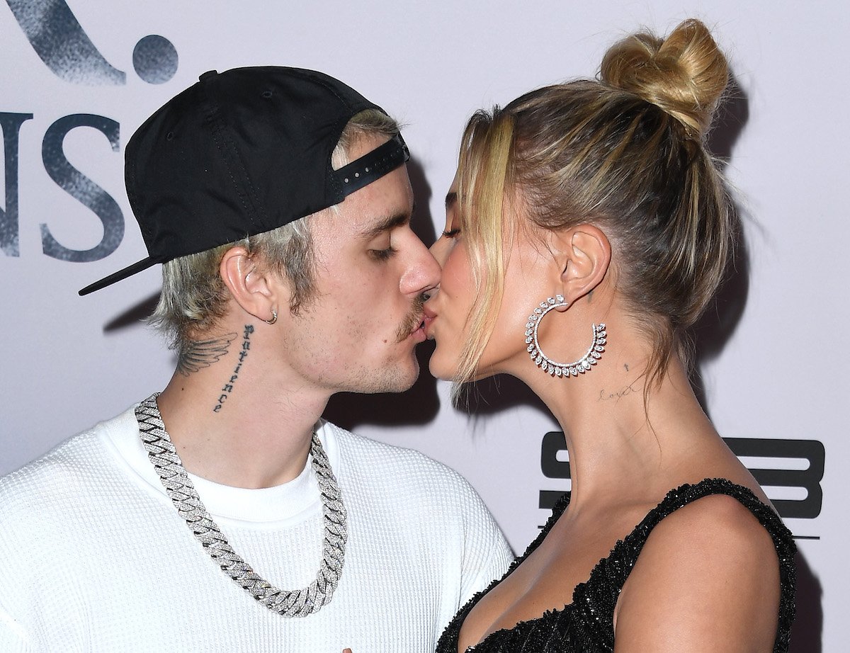 Justin Bieber and Hailey Bieber kiss at an event.