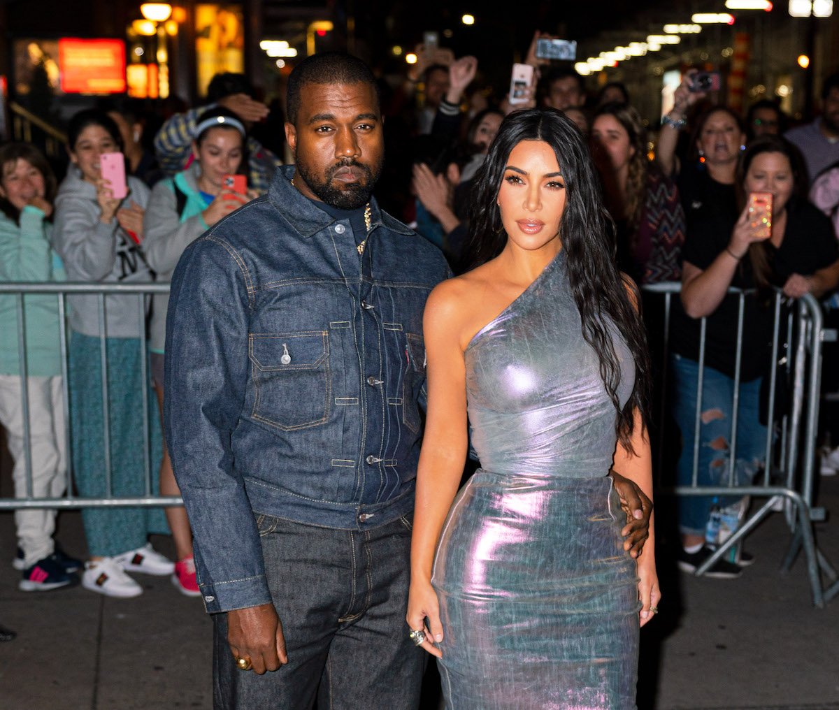 Kanye West and Kim Kardashian West pose together at an event.