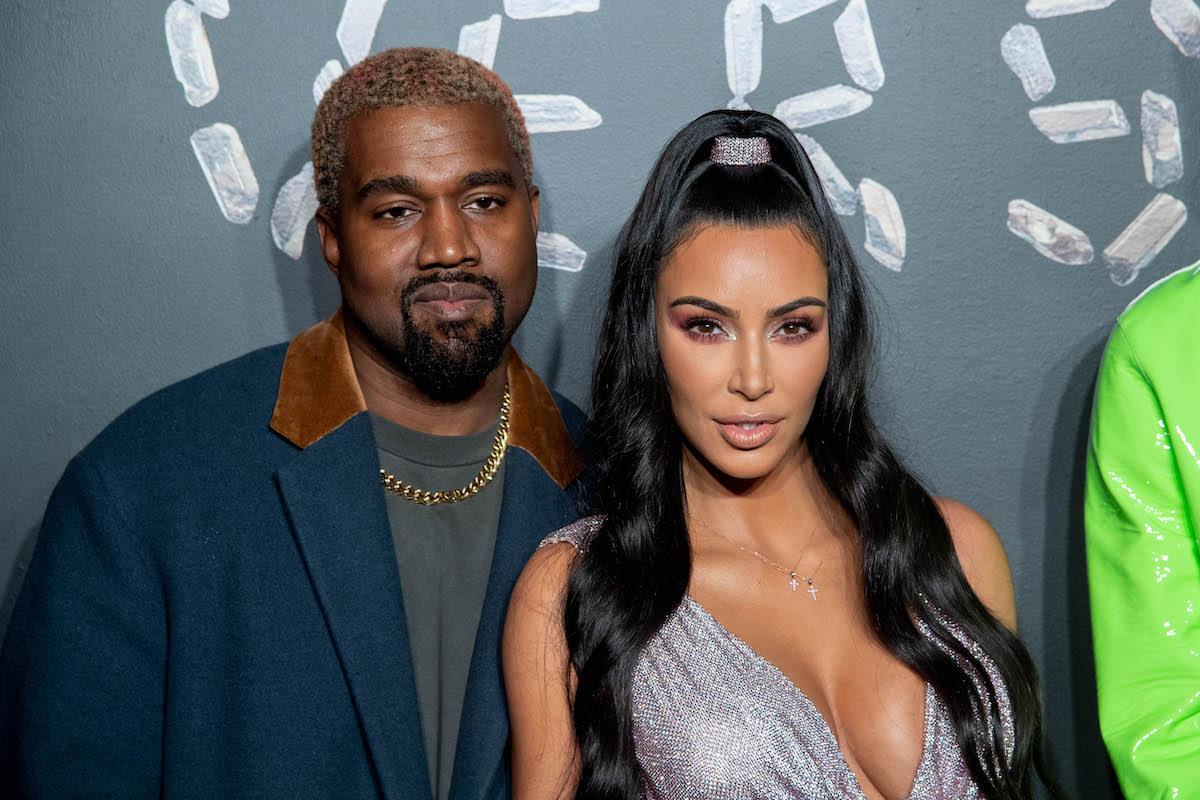 Kanye West and Kim Kardashian West pose together at an event.