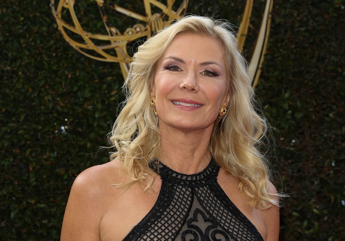 'The Bold and the Beautiful' actor Katherine Kelly Lang wearing a black dress and standing in front of an Emmy statue.