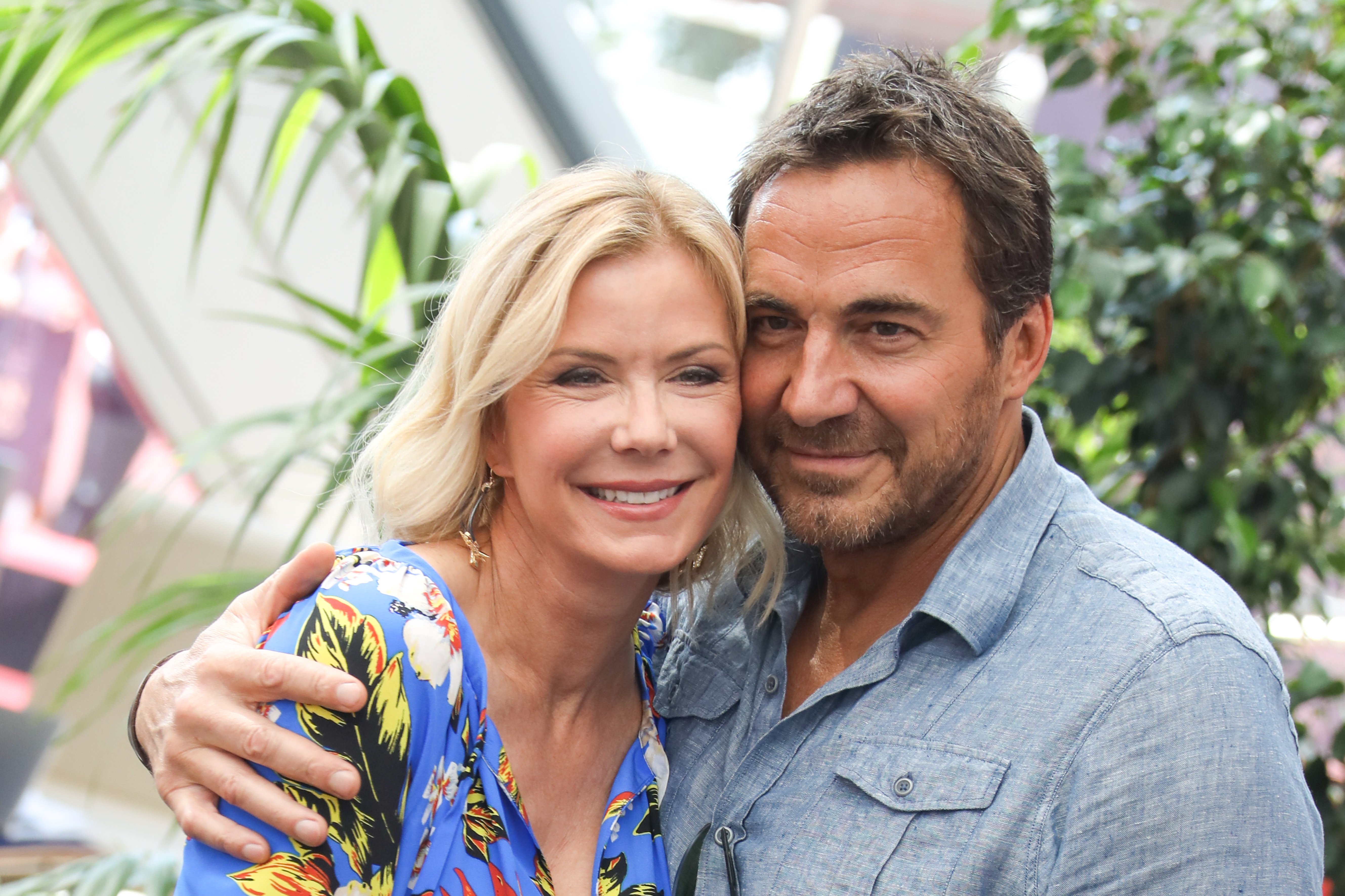 'The Bold and the Beautiful' actor Katherine Kelly Lang in a blue floral dress, and Thorsten Kaye in a blue shirt, share a hug.