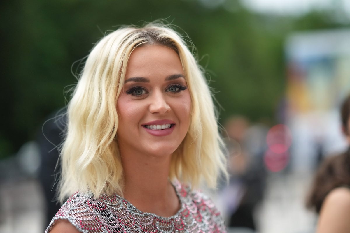 Katy Perry smiling in front of a blurred background