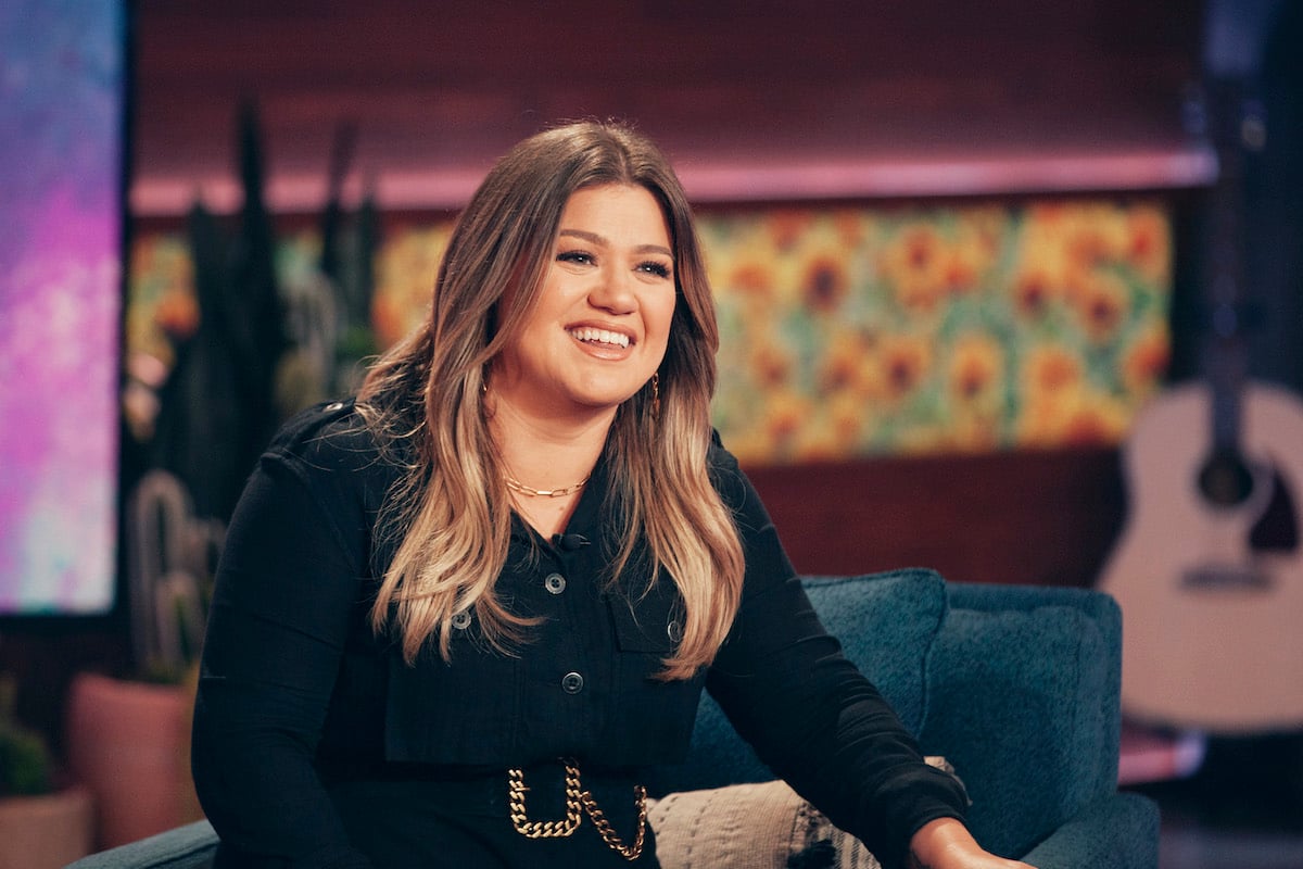 Kelly Clarkson laughing, seated