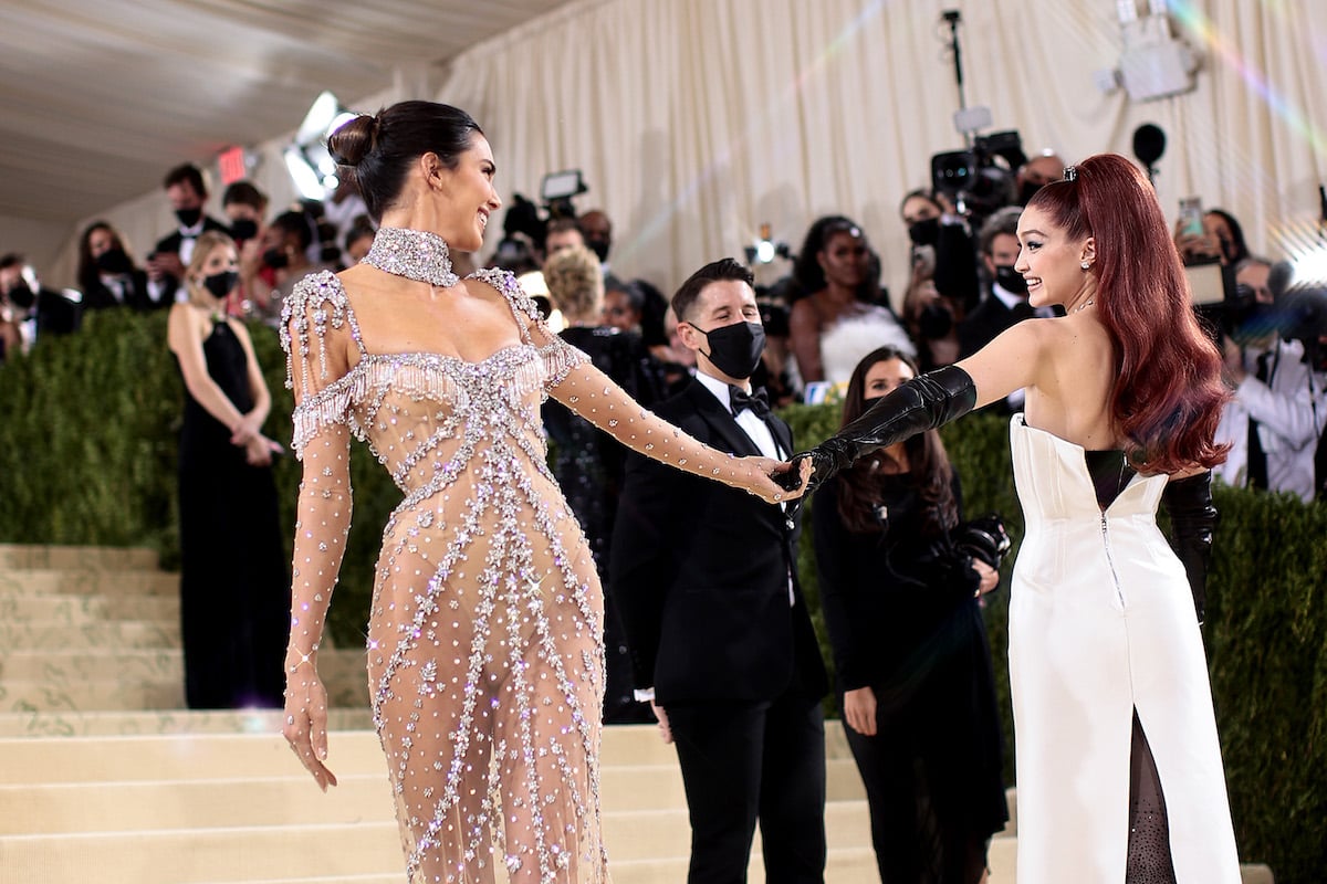 Kendall Jenner and Gigi Hadid hold hands at the 2021 Met Gala.