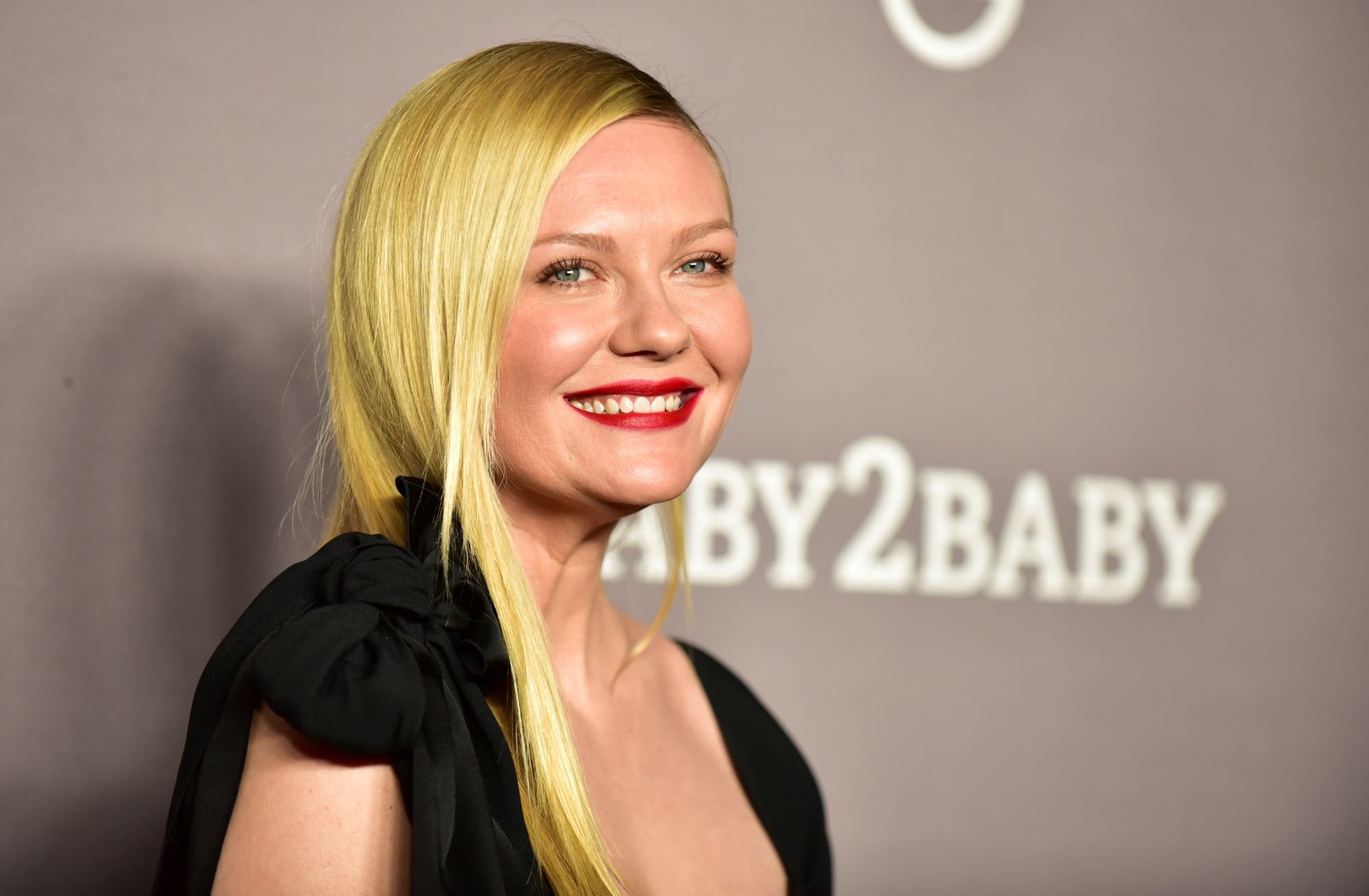 'Spider-Man' star Kirsten Dunst wears a black dress that ties in a bow on her shoulder.