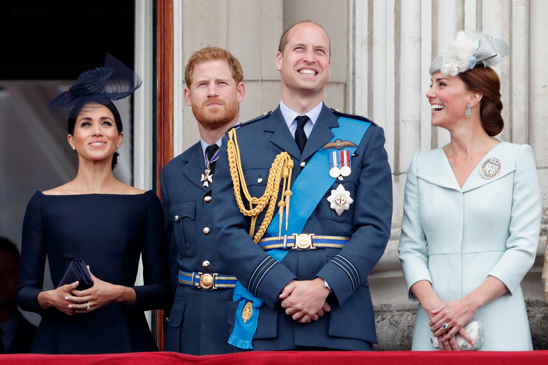 (L to R): Meghan Markle, Prince Harry, Prince William, and Kate Middleton watching a flypast from the balcony of Buckingham Palace