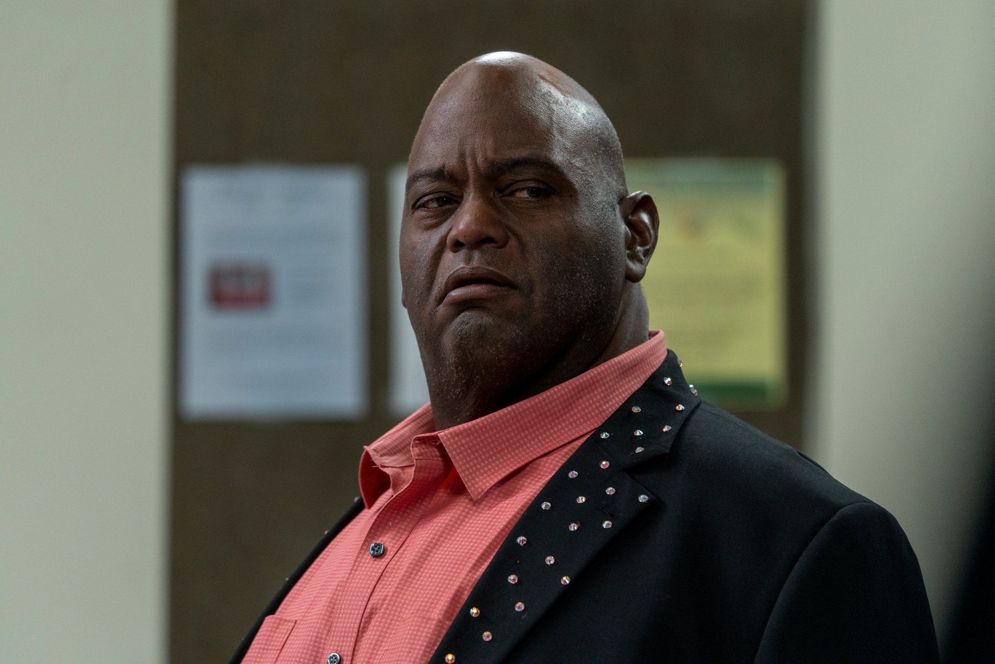 Lavell Crawford as Huell in 'Better Call Saul.' The last time fans saw the character was in 'Breaking Bad' Season 5. In this image, he's wearing a pink collared shirt and dark jacket.