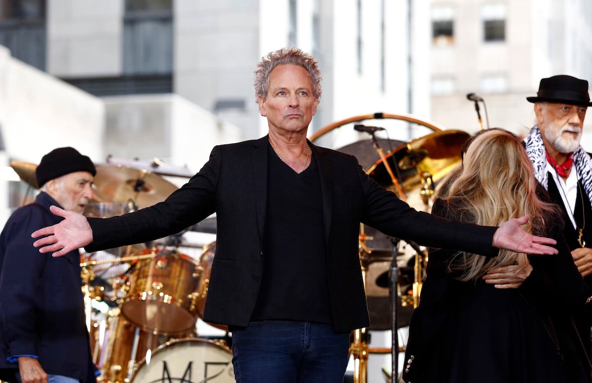 Lindsey Buckingham spreads his arms on stage.