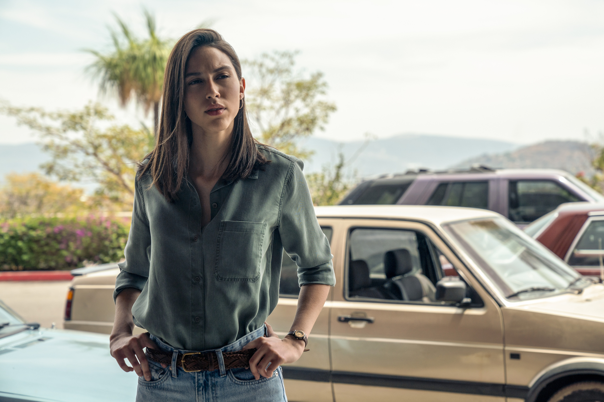 Luisa Rubino wearing a green shirt with blue jeans in 'Narcos: Mexico' Season 3.