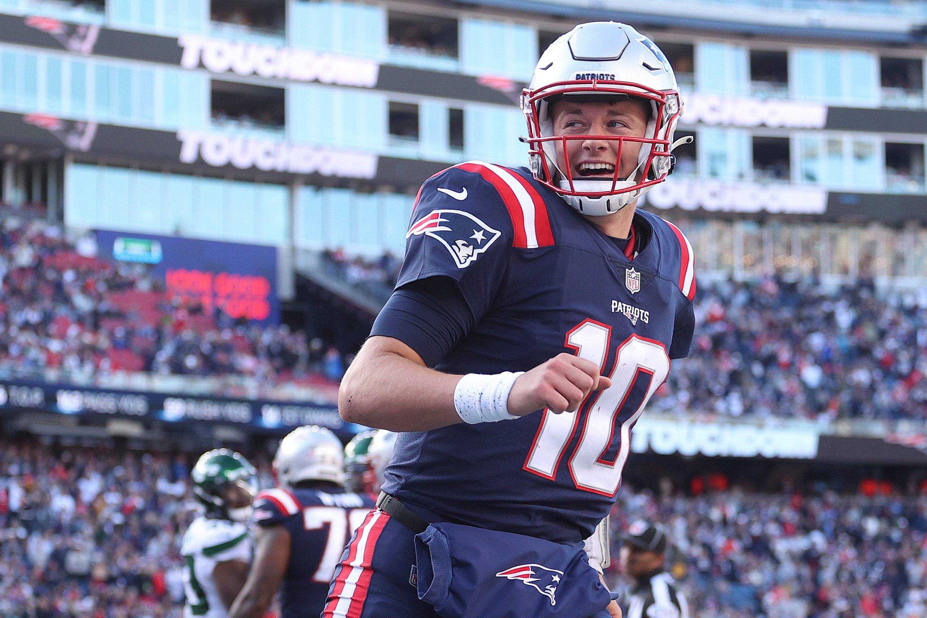 Mac Jones celebrates after a touchdown during the second half in the game