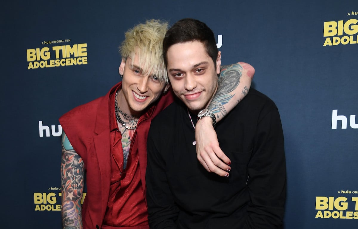 Machine Gun Kelly and Pete Davidson smile and pose together.