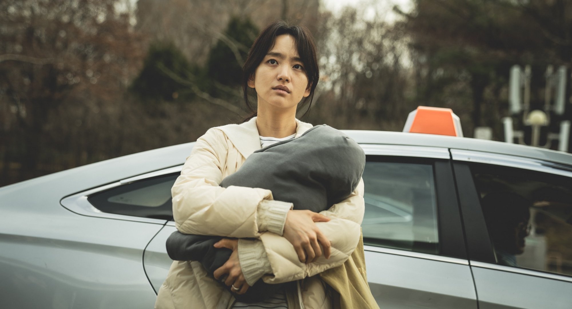 Main character Song So-hyun from Netflix's 'Hellbound' holding her baby.