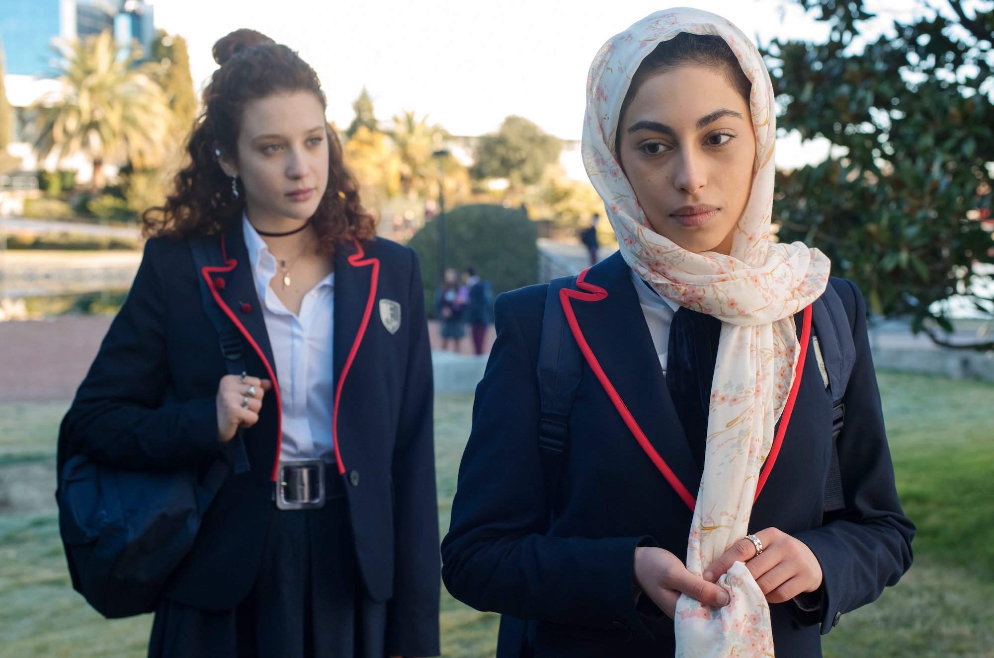 Maria Pedraza, and Mina El Hammani wearing school uniforms in 'Elite' Season 1.