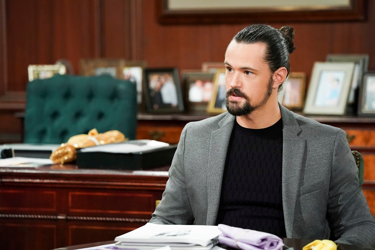 'The Bold and the Beautiful' actor Matthew Atkinson wearing a grey suit and black shirt; sitting in an office.