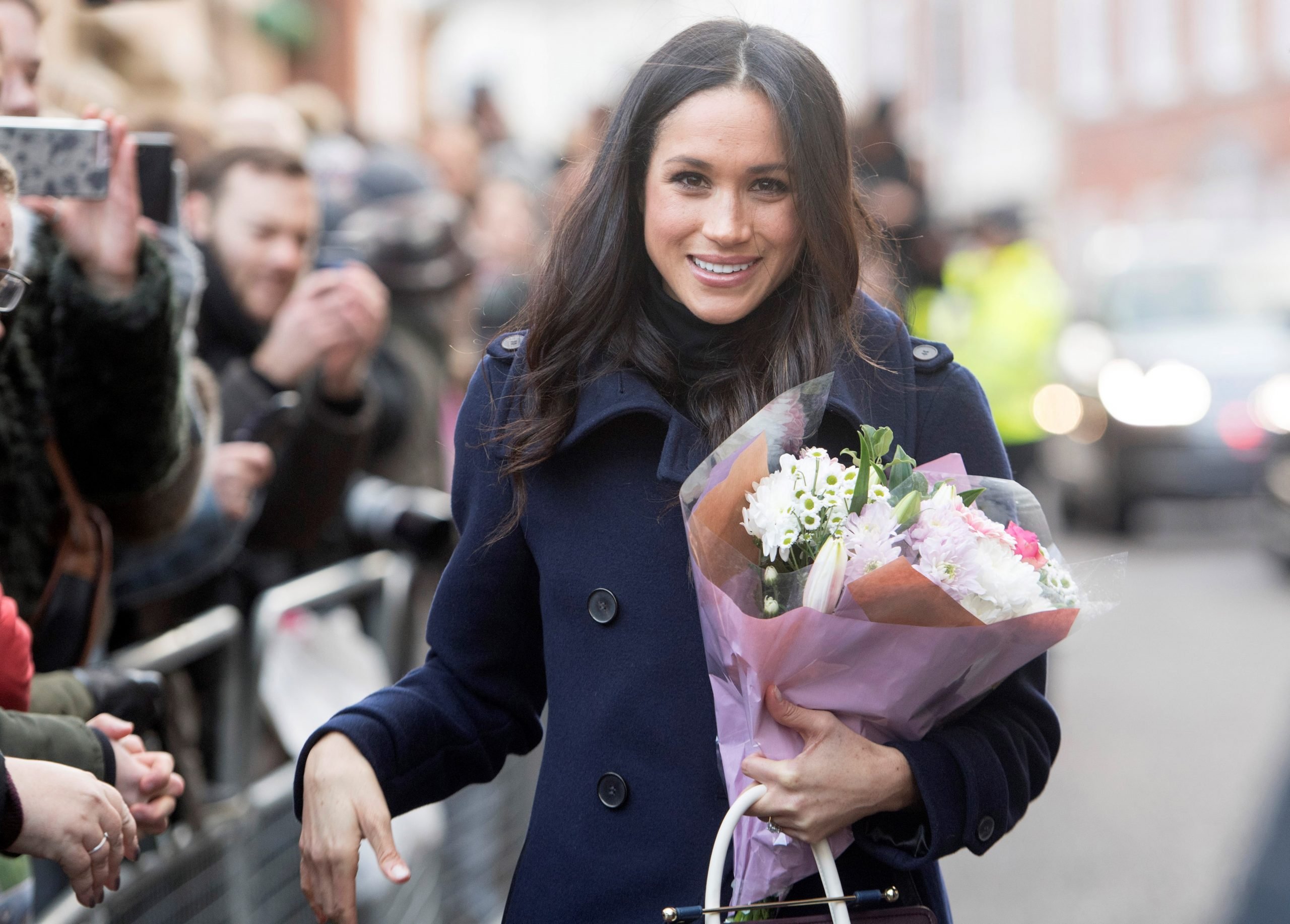 Meghan Markle holding a bouquet of flowers in Nottingham on her first official public engagement