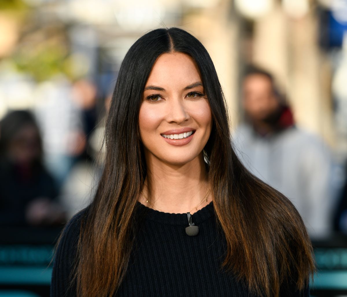 Olivia Munn smiling in black