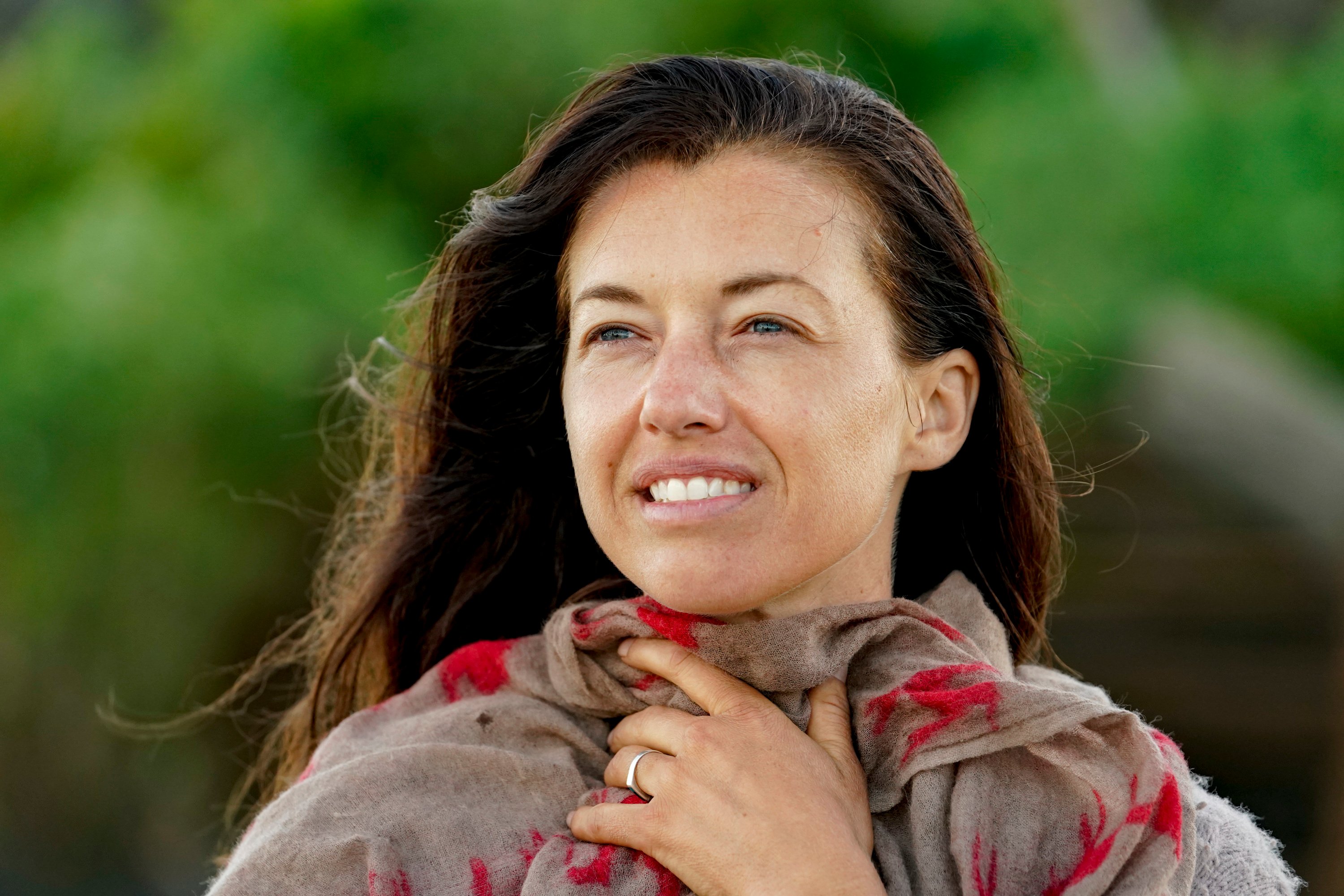 'Survivor' star Parvati Shallow clutches a tan and red scarf to her neck.