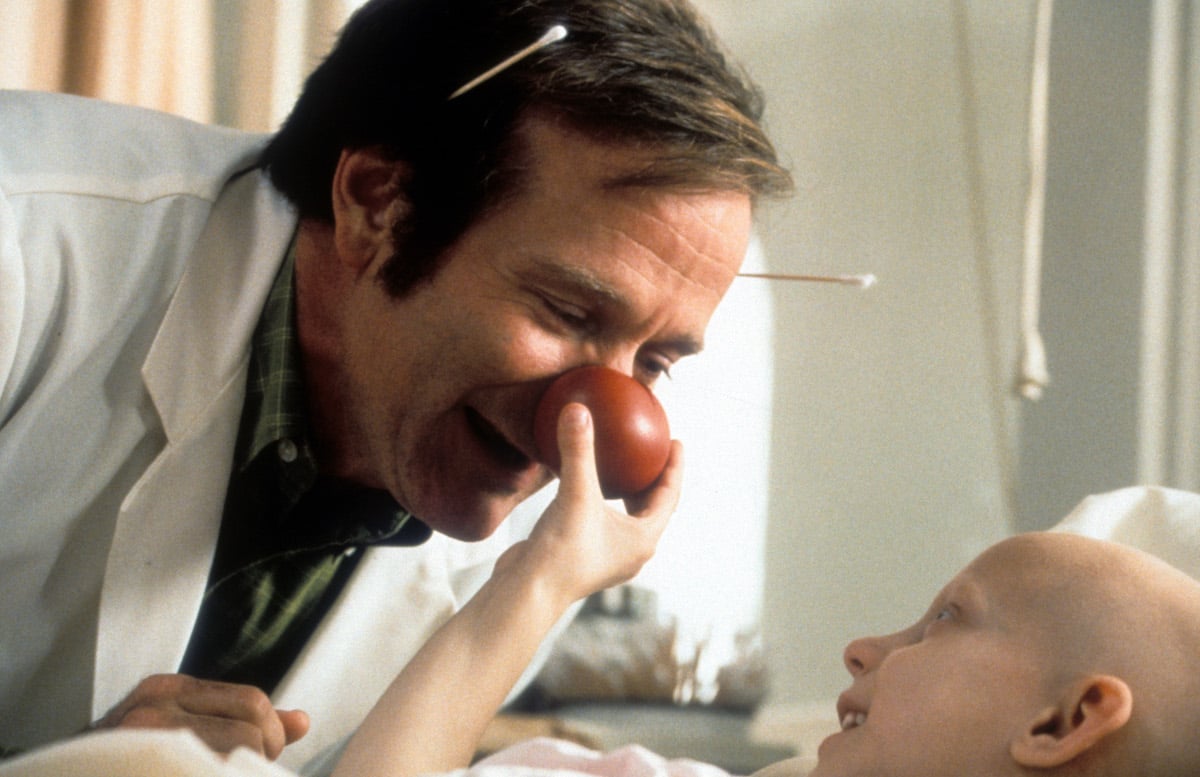 Robin Williams visits a sick child in a scene from the film 'Patch Adams' in 1998