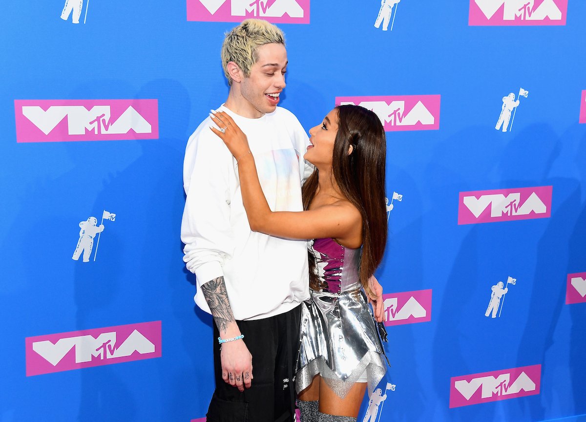 Pete Davidson and Ariana Grande pose together at an event.