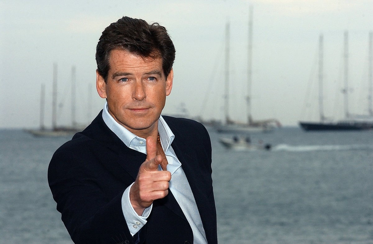 Pierce Brosnan doing a James Bond pose in a suit