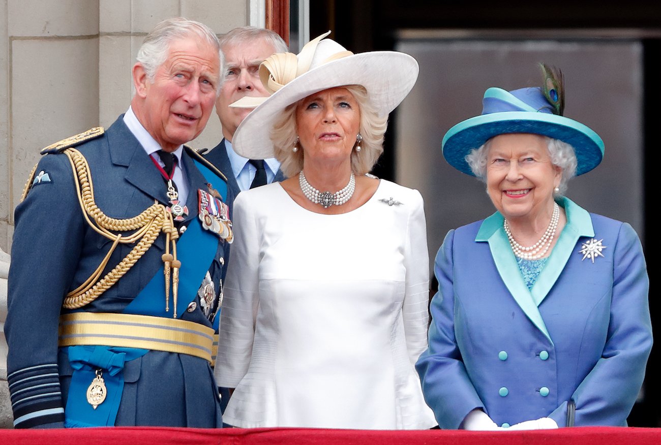 Prince Charles, Prince Andrew, Camilla Parker Bowles, and Queen Elizabeth II stand on the balcony of Buckingham Palace