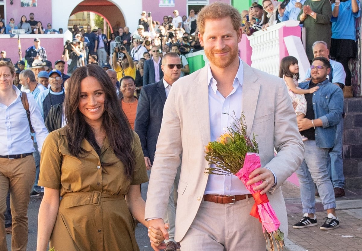 Prince Harry and Meghan Markle walk through streets on Heritage Day celebrations in Cape Town