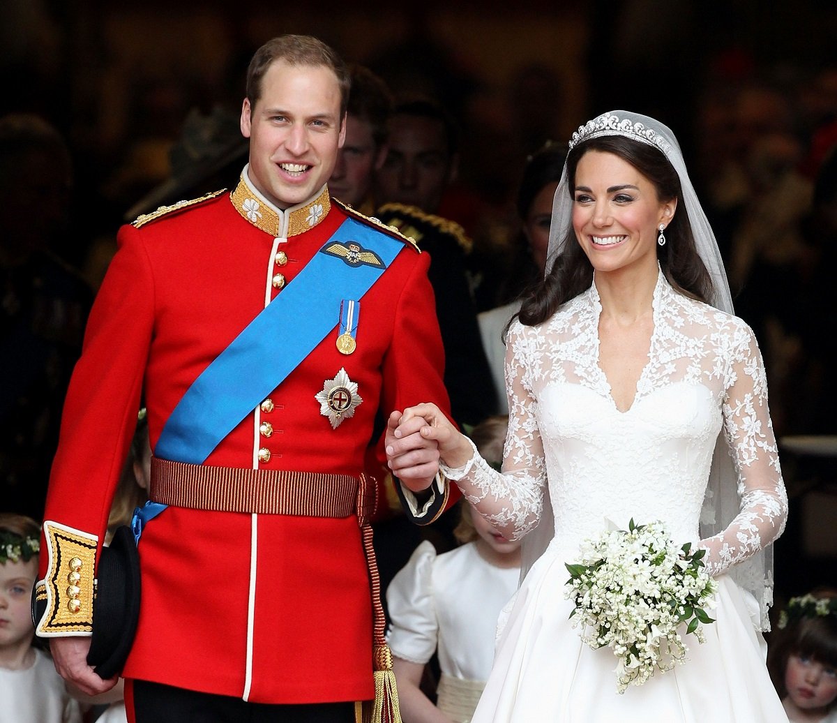 Prince William and Kate Middleton smile as they leave Westminster Abbey after wedding ceremony