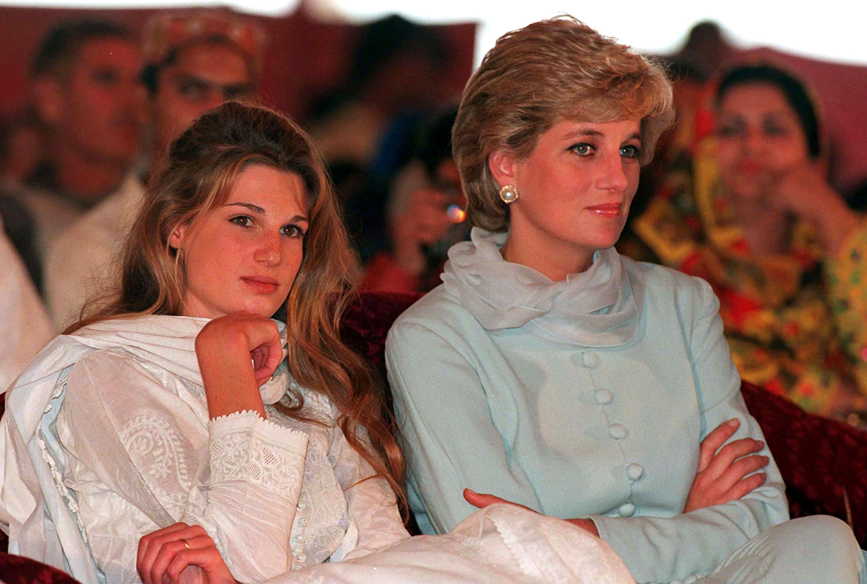 Princess Diana wearing a pale blue shalwar kameez while sitting next to her friend Jemima Khan