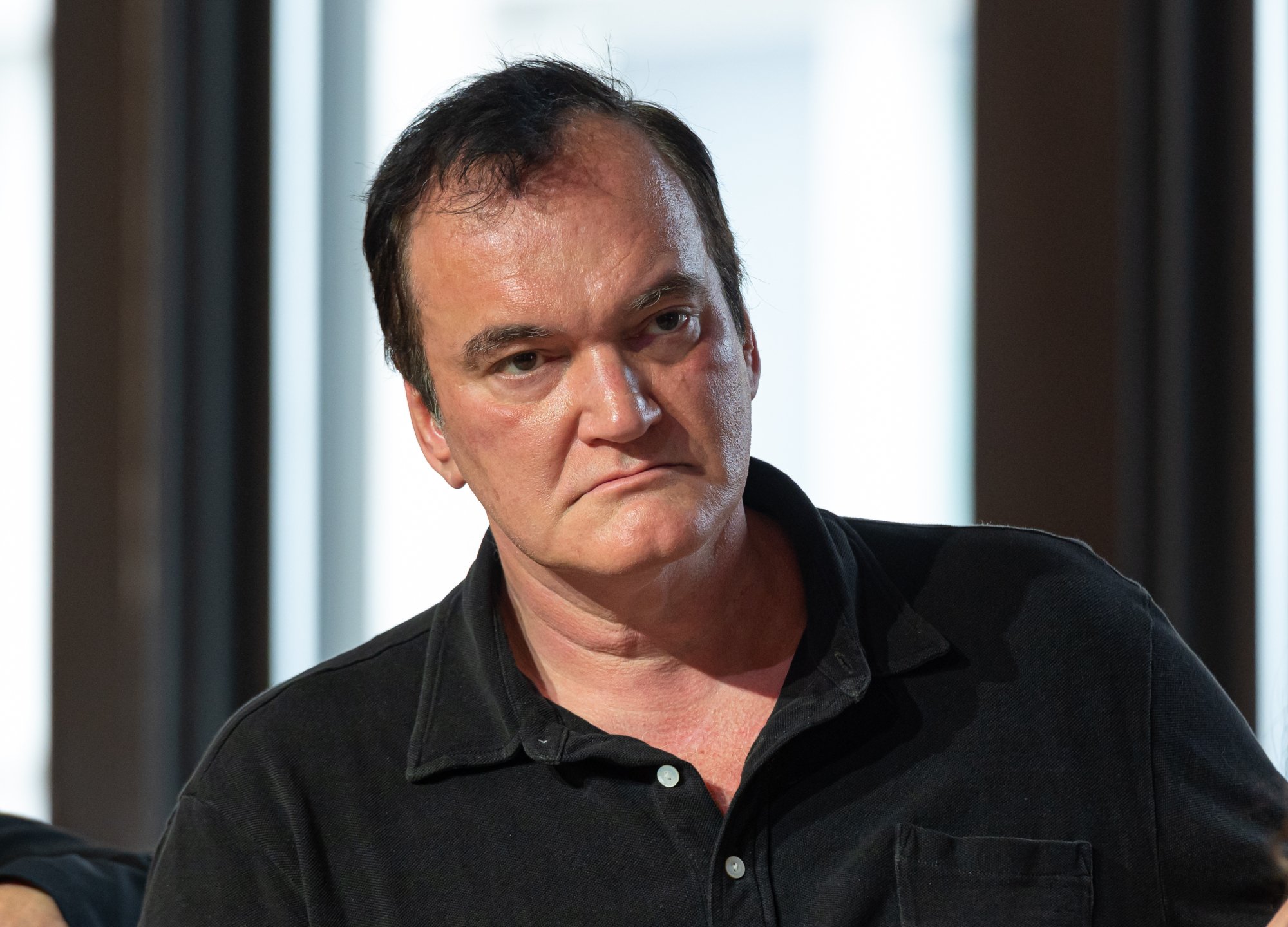 'Pulp Fiction' filmmaker Quentin Tarantino lawsuit after NFT plans wearing a black collared shirt
