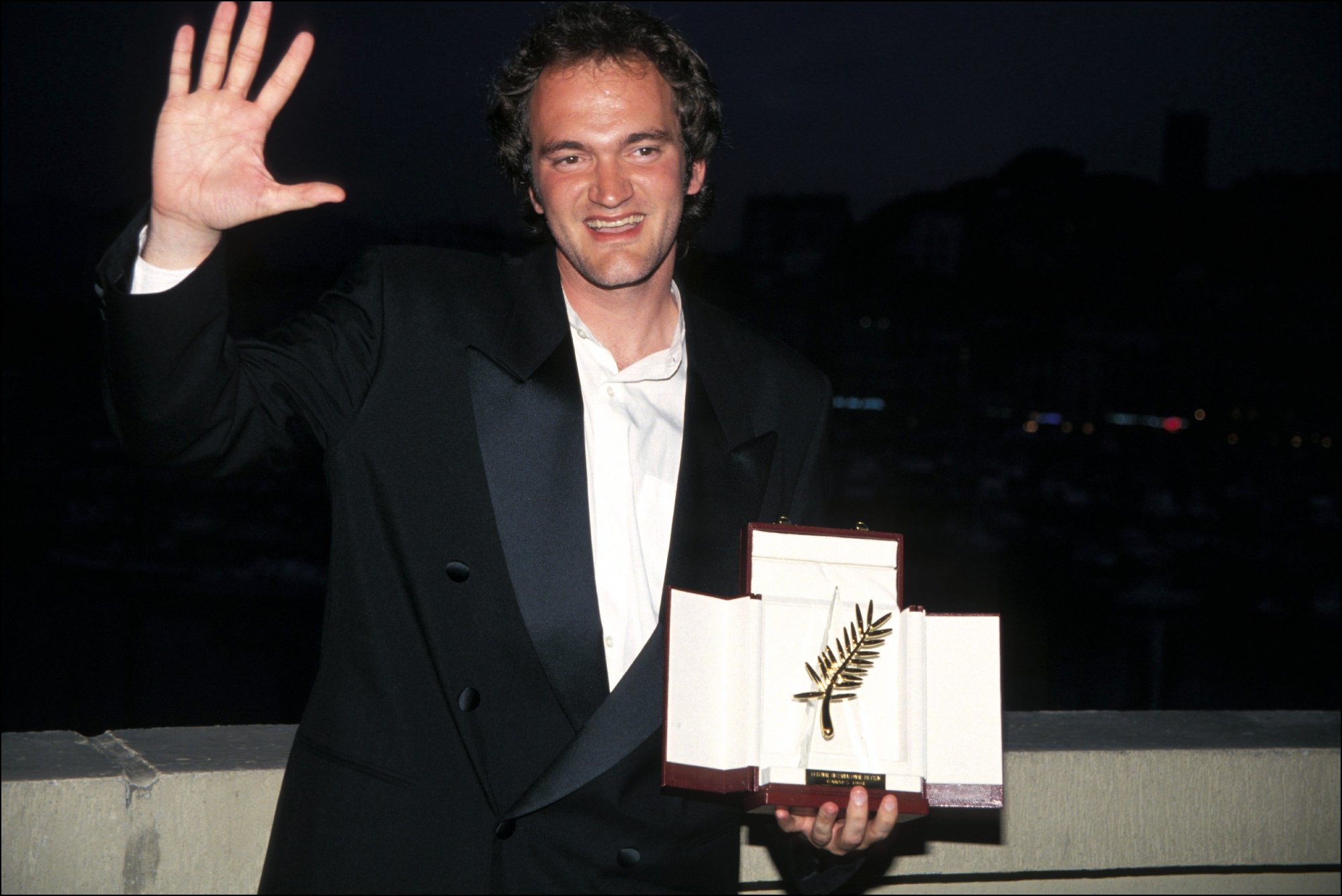 'Pulp Fiction' filmmaker Quentin Tarantino with the Golden palm waving