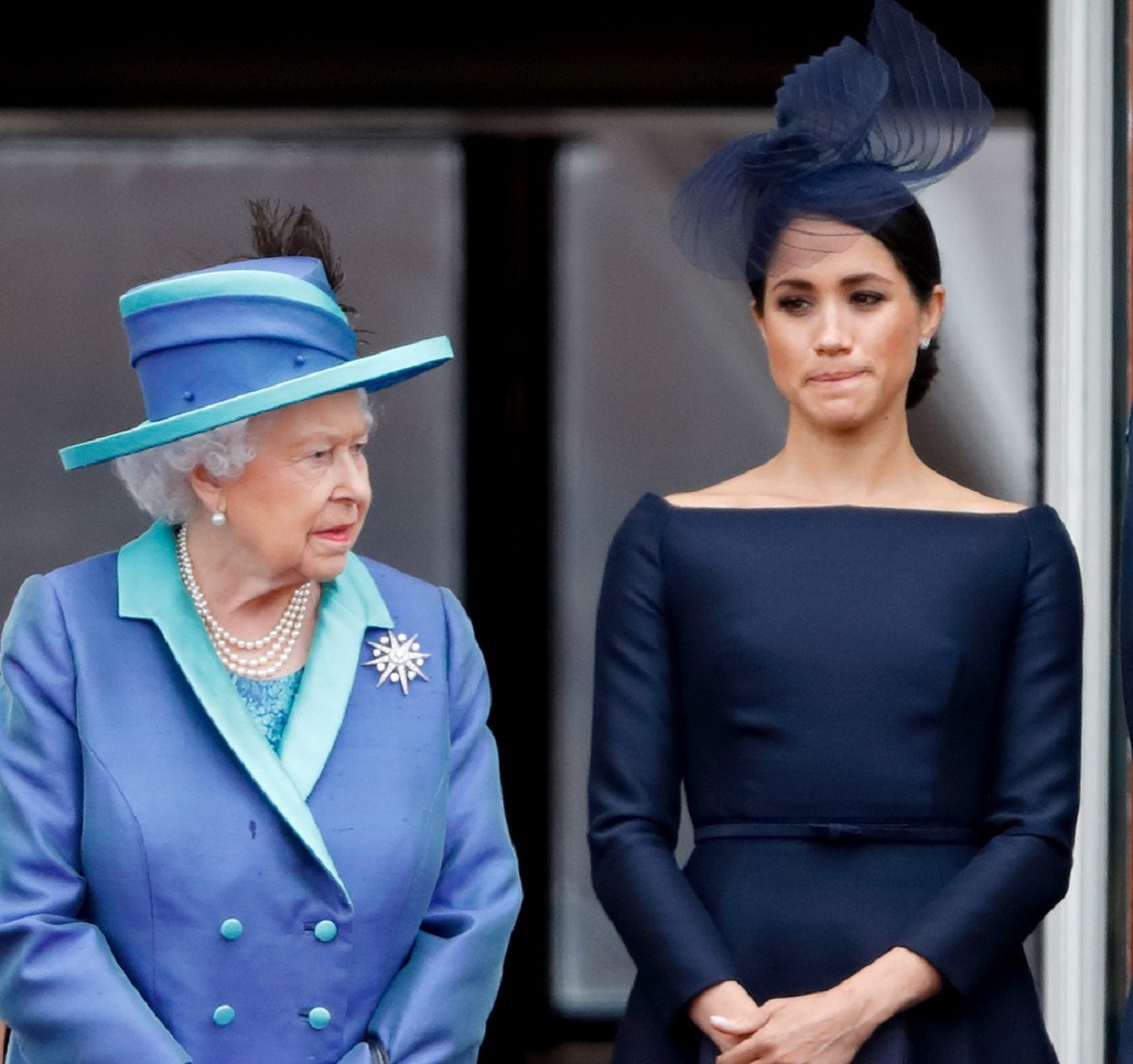 Queen Elizabeth II and Meghan Markle standing on the balcony of Buckingham Palace