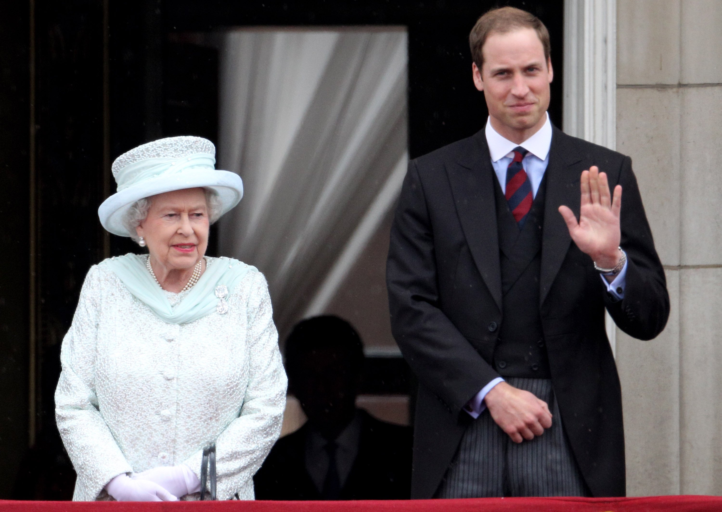 Queen Elizabeth II and Prince William standing on the balcony of Buckingham Palace together after the service of thanksgiving