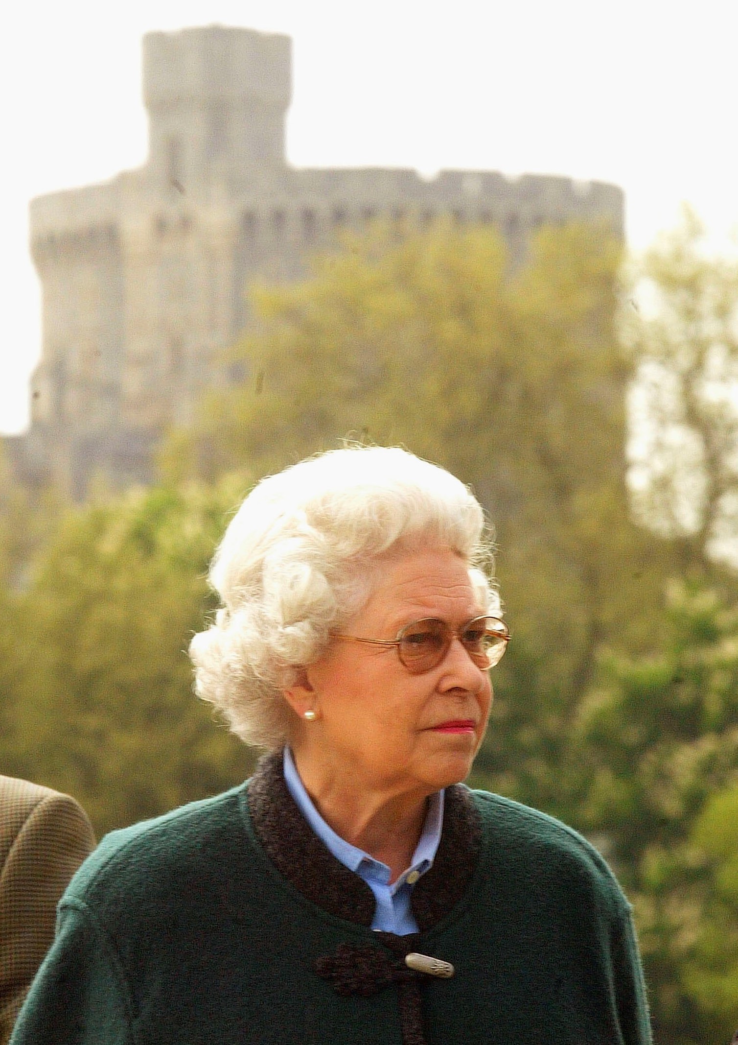 Queen Elizabeth II, framed by Windsor Castle, looks round clothing stalls
