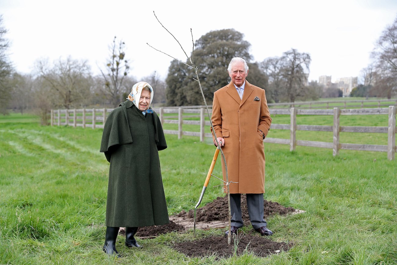 Queen Elizabeth stands next to Prince Charles