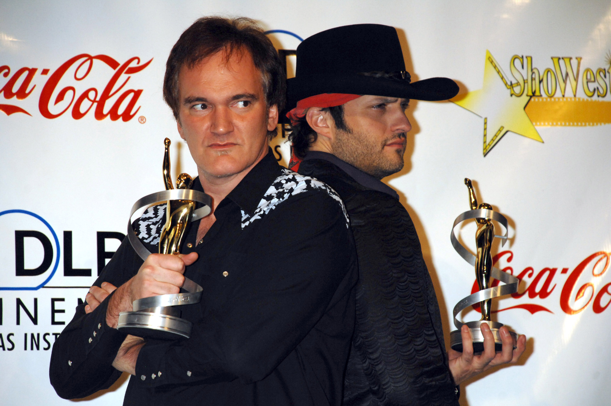 Quentin Tarantino and Robert Rodriguez at the 2007 ShoWest Award Ceremony standing back-to-back holding their awards