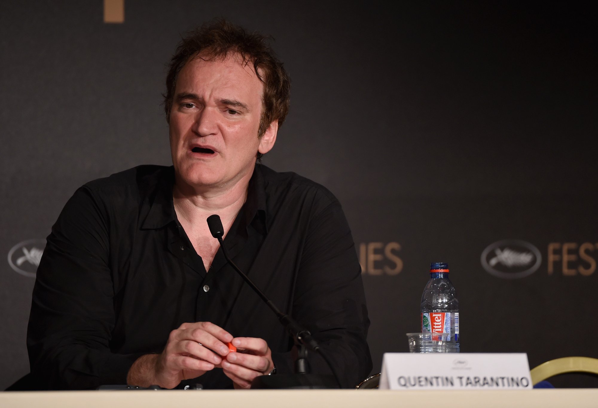 Quentin Tarantino at the Cannes Film Festival talking into a mic